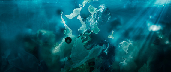 Toxic plastic waste floating underwater in the ocean - obrazy, fototapety, plakaty