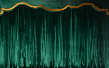 Green curtain of luxurious velvet on the theater stage. Copy space. The concept of music and...