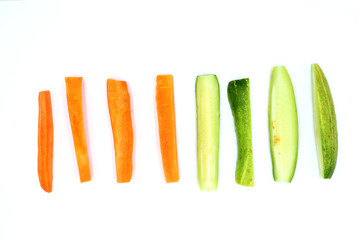 Fresh cucumber and carrots slice isolated on white background