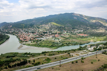 The merger of two rivers into one. The ancient capital of Georgia - city Mtskheta. Hilly terrain,...