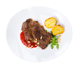 Prepared beef steak with tomatoe ketchup and pine nuts