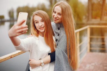 two pretty sisters in a park