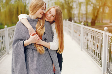 Fototapeta premium two pretty sisters in a park
