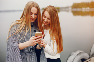 two pretty sisters in a park