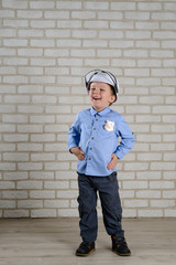 cheerful boy 4 years old plays a policeman, celebrates victory