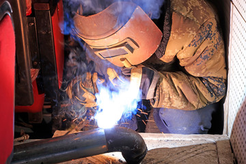 Workers welding operation