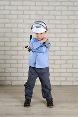 portrait 4-year-old boy plays policeman, childhood dreams, choice of profession