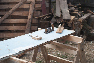 Old carpentry tools for building a house, carpenter's Workplace outdoors, carpenter's tools on a wooden table,