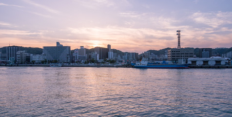 Obraz premium Panoramic view on Skyline of Kagoshima during sunset. Taken from the Harbour View Point. Located in Kagoshima, Kyushu, South of Japan.