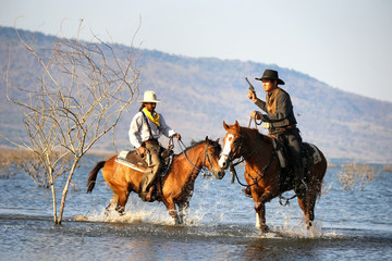 Fototapeta premium cowboy and horse at first light,mountain, river and lifestyle with natural light background