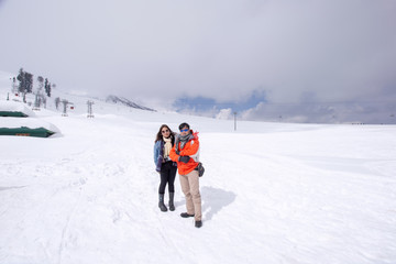 man and woman on ski resort