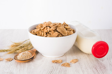 Oats milk and cereals on white wooden table and white background. Copyspace