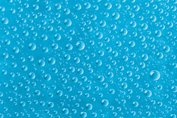 Beautiful water drops of the correct form on a gentle  turquoise background