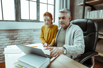 Nice mature man pointing at the laptop