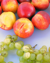 Naklejka na ściany i meble fresh fruit excellent for your health, ready and cut: nectarine, grapes