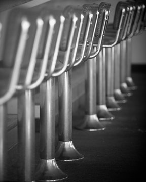 Side view of a row of empty diner, fountain stools, Utah.