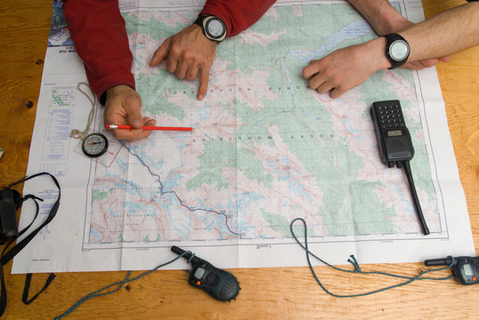 Two men plan out the next day's route in the Canadian Rockies.