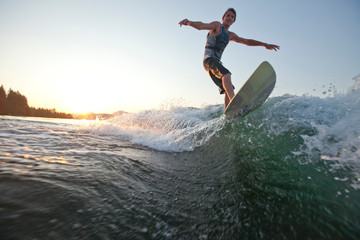 Young man wakesurfing on Lake Pend Oreille in Sandpoint, Idaho.