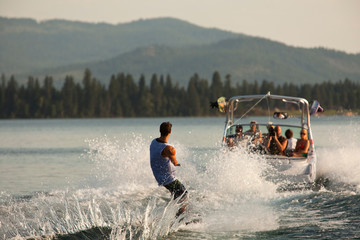 Young man wakeboarding on Lake Pend Oreille in Sandpoint, Idaho.