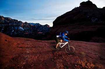 A middle age man celebrates the new year by riding the aptly named Hangover Trail through the red rock country surrounding Sedona, AZ at sunset.