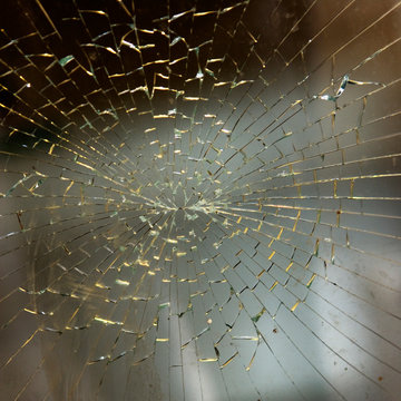 Close-up of spiral pattern in cracked glass.