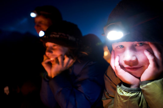Jim Zellers and his two sons Dylan and Ryan talk and laugh by the campfire at night in the backcountry of California.