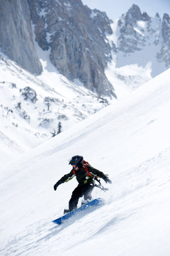 Dylan Zellers makes fresh tracks while snowboarding in the California backcountry.