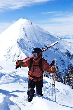 A athletic telemark skier looks out while hiking on the top of Bridger Bowl, Montana.