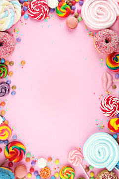 candies with jelly and sugar. colorful array of different childs sweets and treats on pink