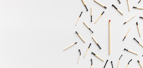 One big matchstick standing out of group of burnt