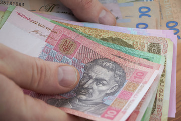 Ukrainian national currency, bills of different values, the calculation between people, the transfer of money.