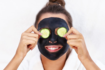 Happy woman having facial in spa salon