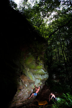 Antonio Caretta, an Italian climber, ascends an overhanging rock feature belonging to a former Nazi occult place deep in the forests surrounding Ibbenburen, North Rhine-Westphalia, Germany on July 9 2011.