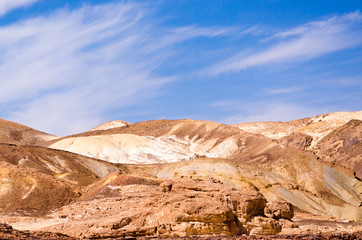 high rocky mountains against the blue sky and white clouds in the desert in Egypt Dahab South Sinai