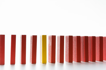 One red wooden block among yellow ones