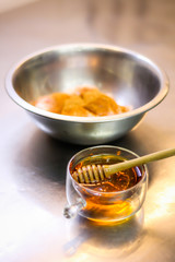 The chef cooking chicken wings in a sauce in the kitchen. Decorating the dishes with colored blobs. Lymon. Chicken. Sauce with honey and seasonings