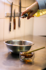 The chef cooking chicken wings in a sauce in the kitchen. Decorating the dishes with colored blobs. Lymon. Chicken. Sauce with honey and seasonings