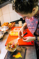 The chef cooking chicken wings in a sauce in the kitchen. Decorating the dishes with colored blobs. Lymon. Chicken. Sauce with honey and seasonings