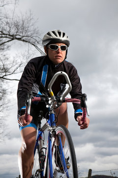 A female cyclist rides her road bike.