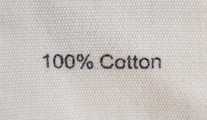 clothes label of cotton fabric texture background closeup