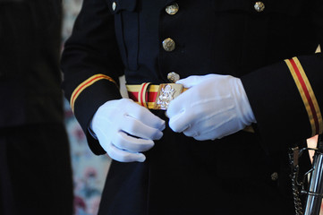 A military groom adjusts his uniform before his wedding on July 20, 2012 in Frederick, Maryland.