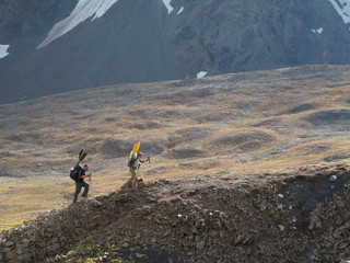 Backpackers climb to the 3,200-foot pass that leads to the headwaters of the Sanctuary River in Denali National Park and Preserve, Alaska September 2009.  The trek begins in the small town of Cantwell and follows Windy Creek into the remote southern side of the park.  The Sanctuary River has become a popular packraft trip.