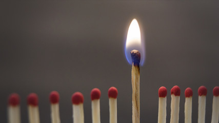 One burning match between spoiled ones on black