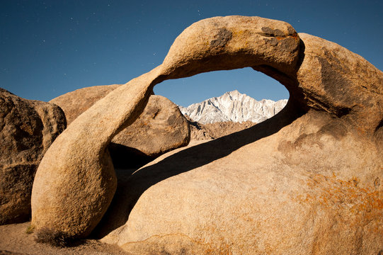 Mobius Arch and Lone Pine peak under moonlight with star trails, Alabama Hills, California