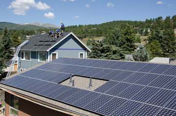 Solar installtion underway behind a large complete solar array in Colorado.