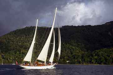 Classic sailing yacht "Sincerity", a 1928 Baglietto designed ketch, cruises along the coast of St. Lucia in the Caribbean.