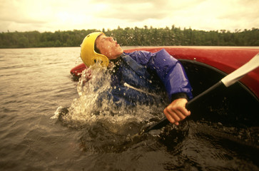 Kayaker struggling for breath as he recovers from a roll.
