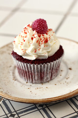 Homemade bakery style red velvet delicious sponge cupcake with white butter cream cream frosting...