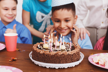 Birthday cake. Boy celebrating b-day and making wish