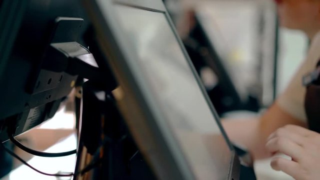 CU: Cashiers are working, touching touch screen, choosing product